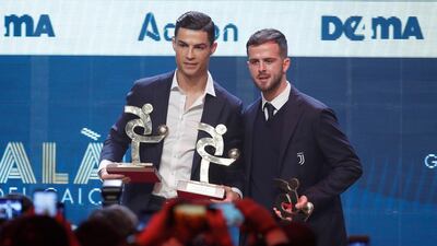 Cristiano Ronaldo, left, and Juventus teammate Miralem Pjanic together after being named in the Gran Gala del Calcio 2019 Best XI. AP Photo