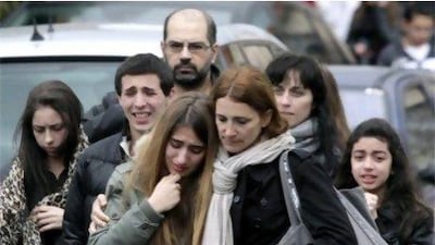 Relatives mourn outside the school in Toulouse, southern France, after a gunman killed three students and a teacher.