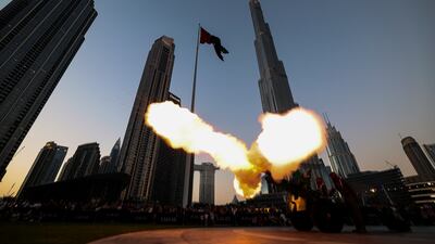Dubai Police officers fire a 1940 British-made 25-pounder cannon in front of Burj Khalifa in Dubai to signal the end of fasting. EPA