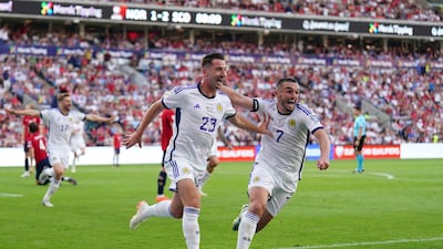 Scotland's Kenny McLean, left, celebrate with John McGinn after scoring the winner against Norway. PA