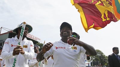 Sri Lankan bowler Rangana Herath, right, acknowledges as the crowd cheers him, after Sri Lanka won the test series 3-0 against Australia, in Colombo, Sri Lanka, on Wednesday. (AP)