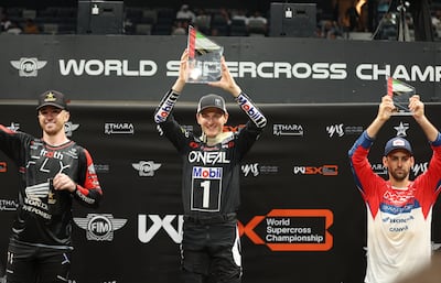 Joey Savatgy of the US, centre, poses on the podium after the 2023 FIM World Supercross Abu Dhabi Grand Prix Championship in Abu Dhabi. EPA
