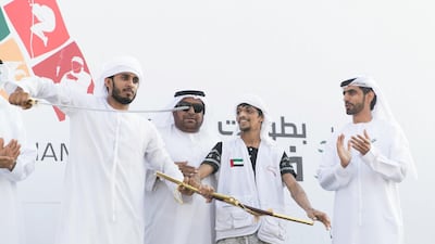 Ghadayir Al Buloushi, 2nd to right, wins first place at the third edition of the National Day Camel Marathon. Reem Mohammed / The National