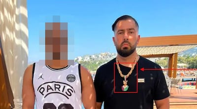 Rawa Majid wearing a necklace with the distinctive Foxtrot symbol