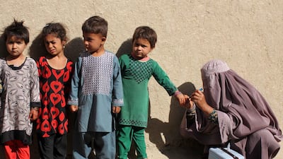 A health worker marks the little finger of a child after administering polio vaccination to children in Kandahar, Afghanistan. EPA