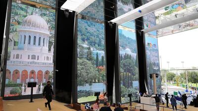 Pictures are displayed on screens during the Israel day celebration.
