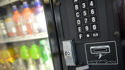 A drinks vending machine accepts coins. Retailers, vending machine operators and other small firms could face costs to alter coin slots. Bethany Clarke / Getty Images
