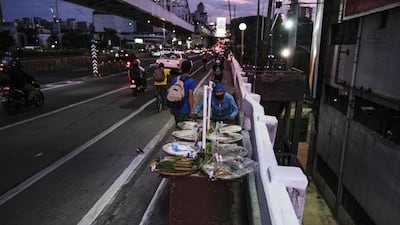 A street vendor pushes a food cart along the Epifanio de los Santos Avenue highway in Metro Manila, the Philippines. Bloomberg