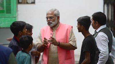 Abhinandan Patha speaks with youths as he campaigns. AFP