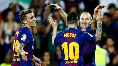 Barcelona's Andres Iniesta, right, celebrates after scoring against Malaga at Camp Nou. Manu Fernandez / AP Photo