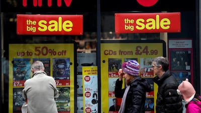 Pedestrians walk past an HMV shop in central London. Reuters