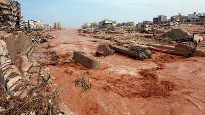 People survey the damage from the floods in Derna last year.