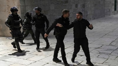 A Palestinian worshipper is led away by Israeli police at Al Aqsa Mosque compound. AP