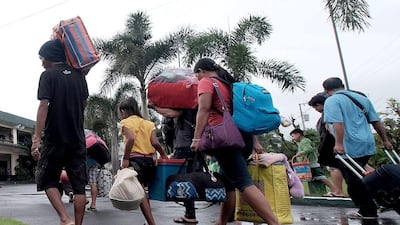 Filipino villagers carrying belongings enter a school turned into a temporary evacuation center on Christmas eve in the town of Tabaco, Albay province, Philippines, 24 December 2016. Authorities evacuated thousands in coastal villages in Bicol region where Typhoon Nock-ten is expected to make landfall on Christmas Day. EPA/ZALRIAN SAYAT