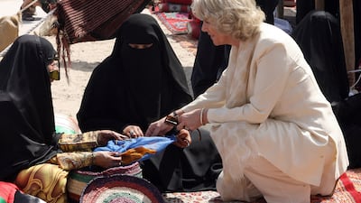 The Duchess of Cornwall talks to Emirati women in Dubai's historical district of Bastakiah in February 2007. AFP