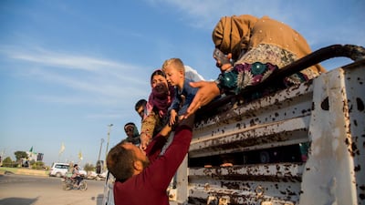 Syrians fleeing Turkish advance arrive to the town of Tal Tamr in north Syria. Syrian government troops moved into towns and villages in northern Syria on Monday, setting up a potential clash with Turkish-led forces advancing in the area as long-standing alliances in the region begin to shift or crumble following the pullback of U.S. forces. AP Photo