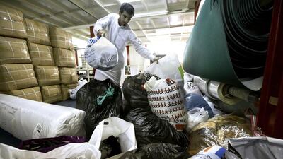 Volunteers in a Ras Al Khor warehouse yesterday faced a big task to sort out the many donations for war refugees in Syria. Jaime Puebla / The National
