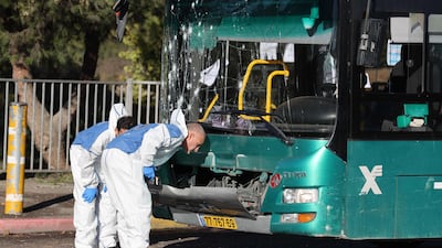 Israeli forensic experts at work at the scene of an explosion at a bus stop in Jerusalem on November 23. One person was killed and at least 15 were injured in two separate explosions, security and medical officials said. AFP