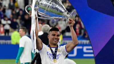 Real Madrid's Casemiro celebrates with the trophy after his side's Uefa Champions League final victory against Liverpool at the Stade de France on May 28, 2022. AFP