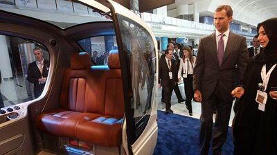 Crown Prince Felipe of Spain looks at one of Masdar City's Personal Rapid Transport pods at the opening of the World Future Energy Summit in Abu Dhabi yesterday.