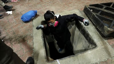 A protester tries to escape through a sewage tunnel inside the Hong Kong Polytechnic University campus during protests. REUTERS