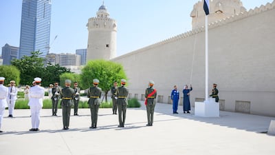 Sheikh Mohamed raises the flag during the ceremony at Qasr Al Hosn. Hamad Al Kaabi / UAE Presidential Court