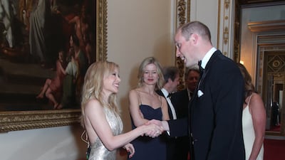 Prince William meets Australian-British singer Kylie Minogue, left, as Lady Helen Taylor looks on, during a reception for the Royal Marsden NHS Foundation Trust at Buckingham Palace, London on June 14, 2018. AFP