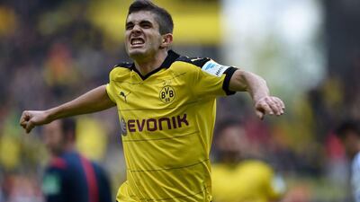 Dortmund’s midfielder Christian Pulisic celebrates scoring the 1-0 goal during the Bundesliga match Borussia Dortmund v Hamburg in Dortmund, western Germany, on April 17, 2016. AFP / PATRIK STOLLARZ
