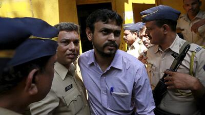 One of the 12 men, convicted of planning several blasts on crowded commuter trains in the financial capital of Mumbai in 2006, is escorted by police to a court in Mumbai. Danish Siddiqui / Reuters