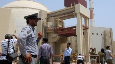 Iran began loading fuel into the Bushehr reactor. Security and journalists are seen here during a ceremony in August which initiated the transfer of Russian supplied fuel.