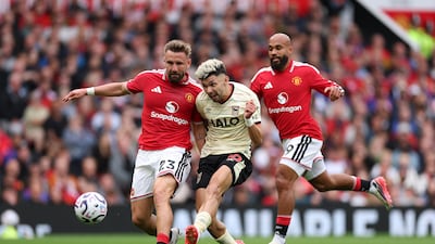 Ipswich's Julio Enciso gets in a shot at goal under pressure from Luke Shaw and Bryan Mbeumo of United. Getty Images