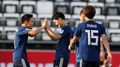 The Japan players celebrate their success.