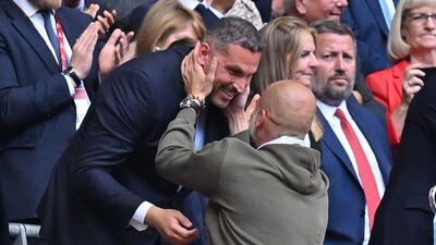 Manchester City manager Pep Guardiola greets Manchester City chairman Khaldoon Al Mubarak as he goes to collect the FA Cup after City's 2-1 win over Manchester United at Wembley, in London, on June 3, 2023. AFP