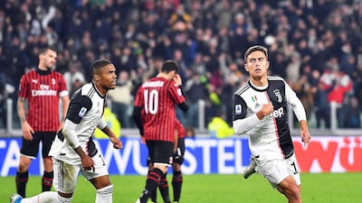 epa07987024 Juventus' Paulo Dybala (R) celebrates after scoring the 1-0 lead during the Italian Serie A soccer match between Juventus FC and AC Milan in Turin, Italy, 10 November 2019. EPA/ALESSANDRO DI MARCO