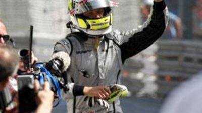 Jenson Button waves to fans as he trots towards the winners' podium after winning last year's Monaco Grand Prix.