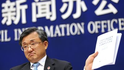 Chinese vice foreign minister Liu Zhenmin holds up a policy paper on China's position on the ruling of an international tribunal on the South China Sea during a press conference in Beijing, on July 13, 2016. The Hague ruled a day earlier against Chinese claims to rights in South China Sea – a ruling Beijing has rejected. How Hwee Young/EPA