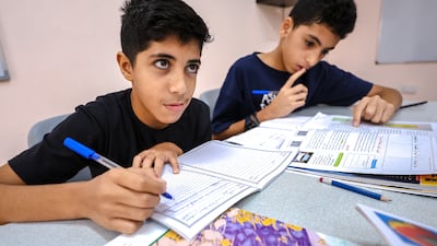 Two Palestinian pupils get to work during lesson time