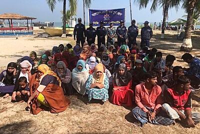 Rohingya refugees wait after their boat capsized near the Saint Martin's island in the Bay of Bengal, near Cox's Bazar, Bangladesh on February 11, 2020. Reuters