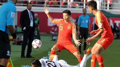 China's midfielder Zhongguo Chi and forward Xiao Zhi fight for the ball with Kyrgyzstan's midfielder Farhat Musabekov. AFP
