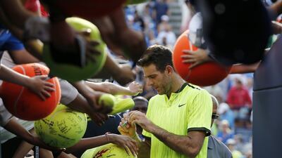 Juan Martin del Potro signs autographs for fans after defeating David Ferrer during the third round of the US Open on Saturday. Kathy Willens / AP Photo
