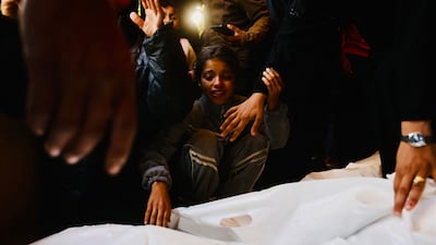 Mourners react as they attend the funeral of Palestinians killed on December 3, by an Israeli strike, at Nasser Hospital in Khan Yunis, southern Gaza Strip on December 4. AFP
