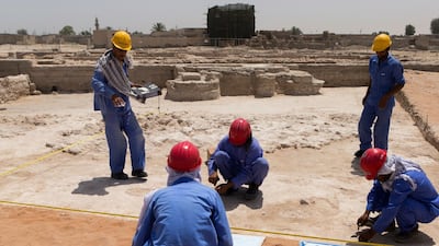Workers at the mosque excavation site at the Jazirat Al Hamra heritage village and archaeological site in Ras al Khamiah last year. Christopher Pike / The National