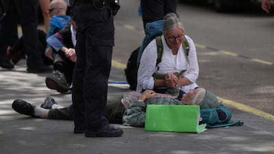 Protesters comfort each other. PA