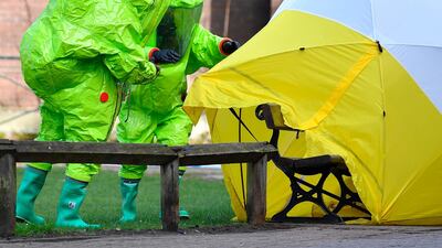 Emergency services place a tent over the bench in Salisbury, southern England, on which a former Russian spy and his daughter were found slumped on March 4, 2018 after being exposed to a nerve agent. Ben Stanstall / AFP