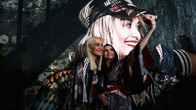 Rita Ora with a fan. Warren Little / Getty Images