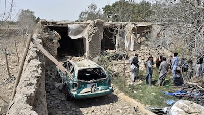 Afghan civilian gather inside a damaged house after a suicide truck bombing in northern Balkh province of Afghanistan. AP