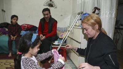US actress Lindsay Lohan is pictured visiting a Syrian refugee family in Istanbul's Sultanbeyli district on September 25, 2016. Sultanbeyli Municipality Press Office/Handout/EPA
