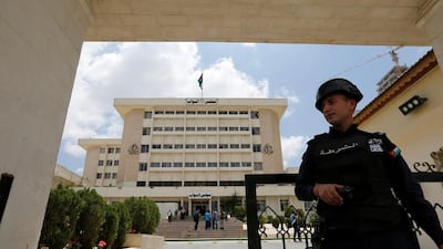 A police officer stands guard in front of the Jordanian parliament in Amman on Sunday. Muhammad Hamed/Reuters