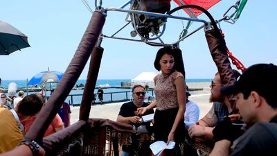 Rosset, centre, takes advice as she rehearses on the set of 'SOS: Survive or Sacrifice'. AFP