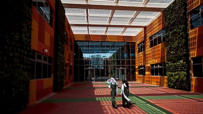 Al Ain, September 11, 2011: Students walk through a courtyard during lunch on the first day of classes at Mezyad School in Al Ain. The courtyard is shaded by solar panels, which provide 15 percent of the schools electricity and the walls are lined with ???